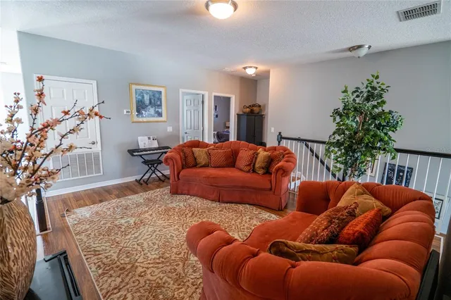 a living room with furniture and a potted plant