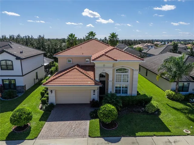 a aerial view of a house with a yard and potted plants