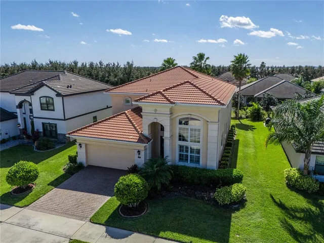 an aerial view of a house with outdoor space and a garden