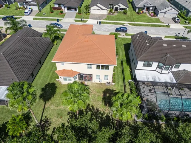 an aerial view of a house with swimming pool and garden