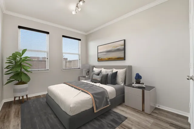 a bedroom with a bed and a potted plant