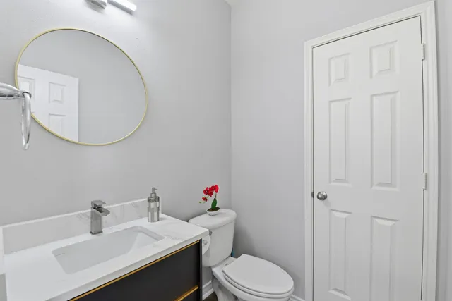 a white toilet sitting next to a bathroom sink