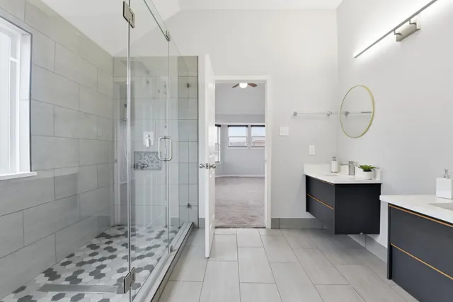 a bathroom with a sink a shower and a mirror