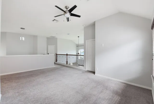 a view of an empty room and kitchen view