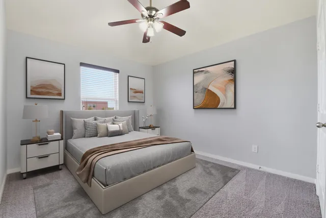 a bedroom with a bed and a painting on the wall