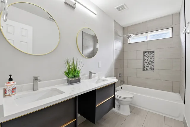 a bathroom with a sink a toilet and a mirror