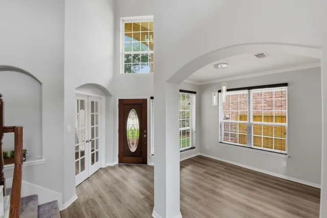 wooden floor in an empty room with a window