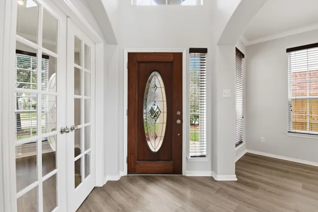 a view of a livingroom with wooden floor and window