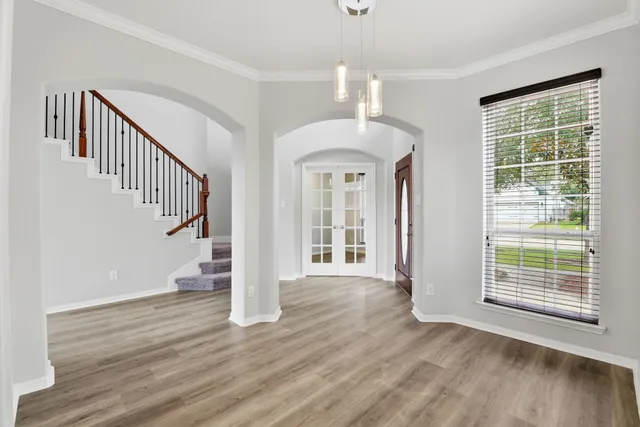 a view of an entryway with wooden floor and windows