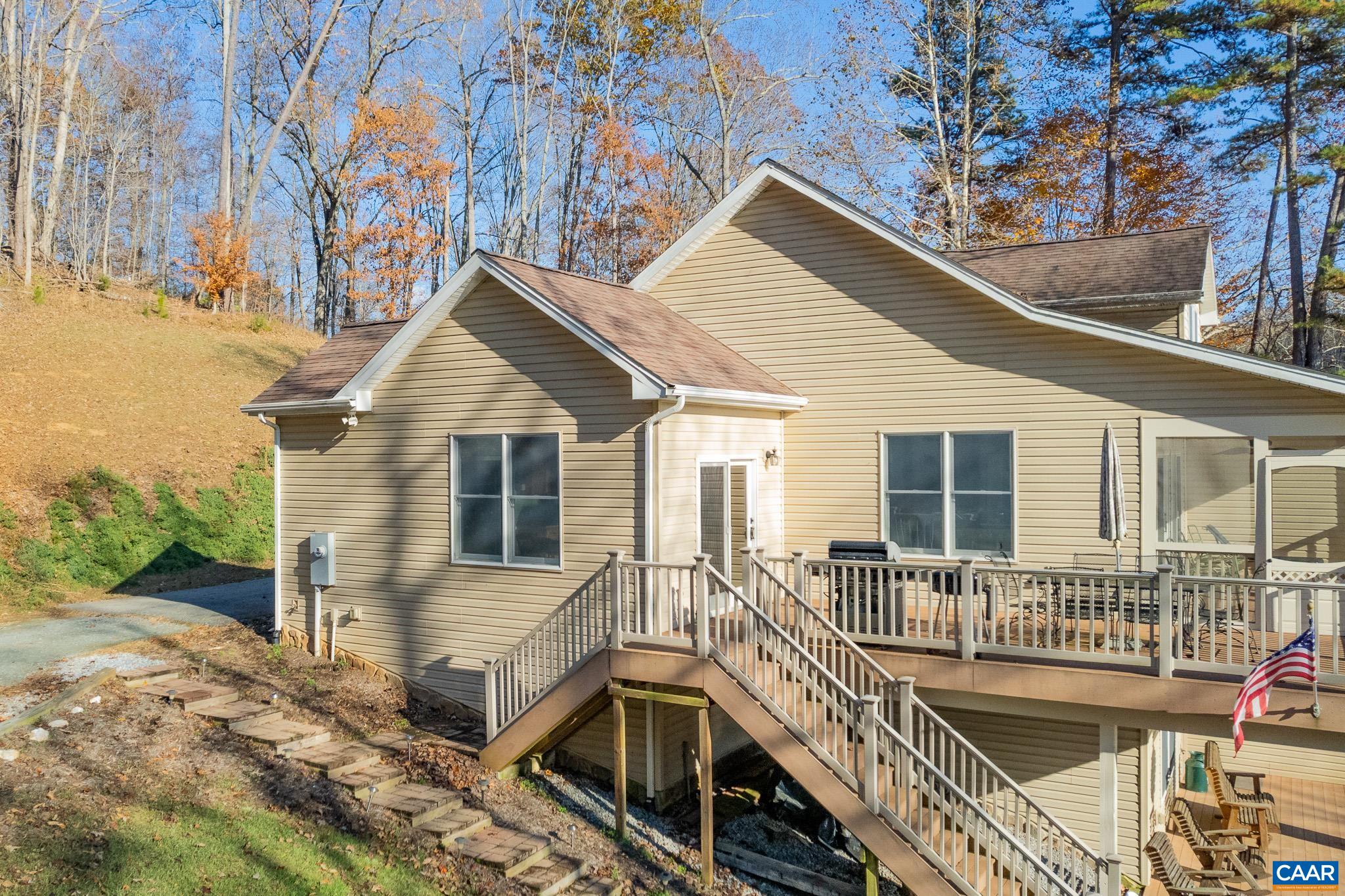 909 Gap Bridge Road Moneta, VA 24121 - Photo 18 of 75 a view of a house with wooden deck and furniture