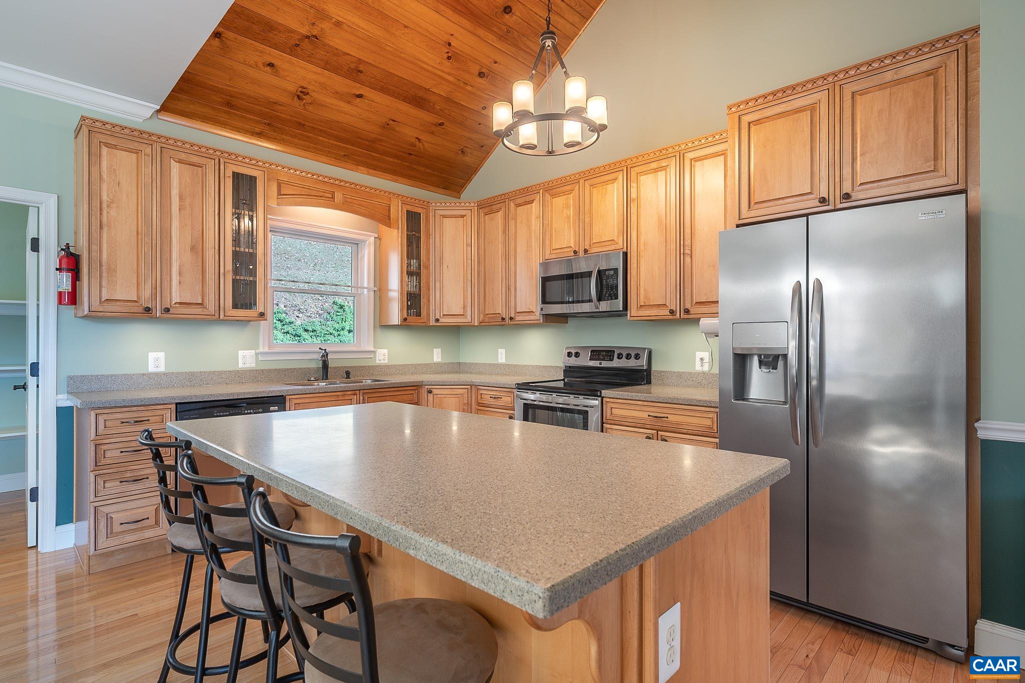 909 Gap Bridge Road Moneta, VA 24121 - Photo 29 of 75 a kitchen with stainless steel appliances granite countertop a refrigerator a sink a stove and chairs
