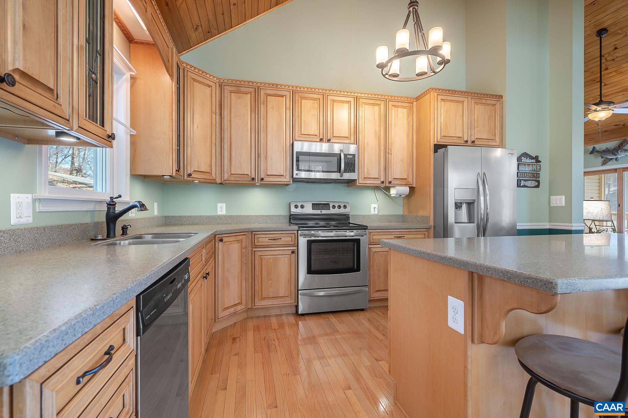 909 Gap Bridge Road Moneta, VA 24121 - Photo 30 of 75 a kitchen with stainless steel appliances granite countertop a sink a stove and a refrigerator