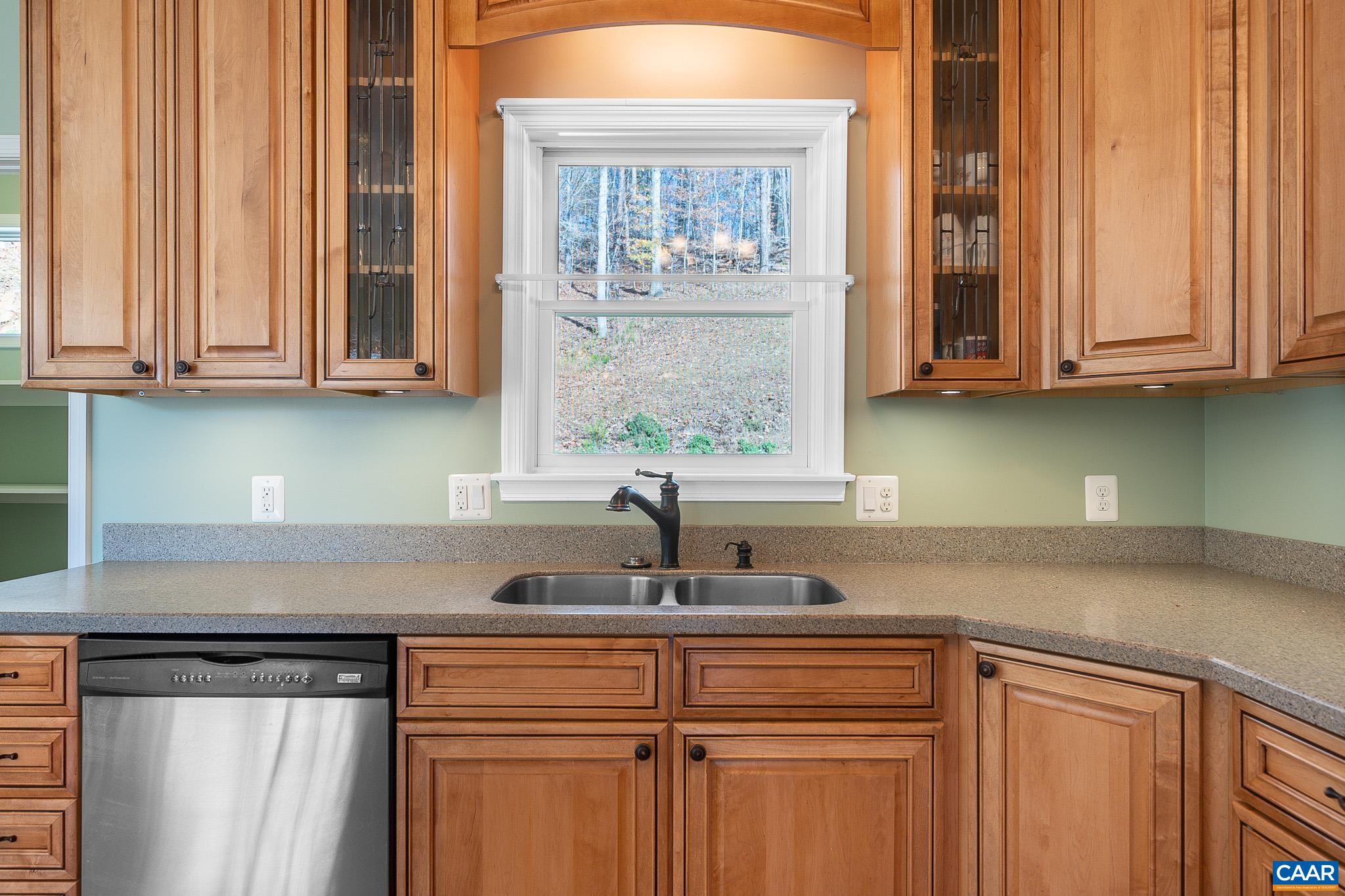 909 Gap Bridge Road Moneta, VA 24121 - Photo 31 of 75 a kitchen with stainless steel appliances white cabinets and a window