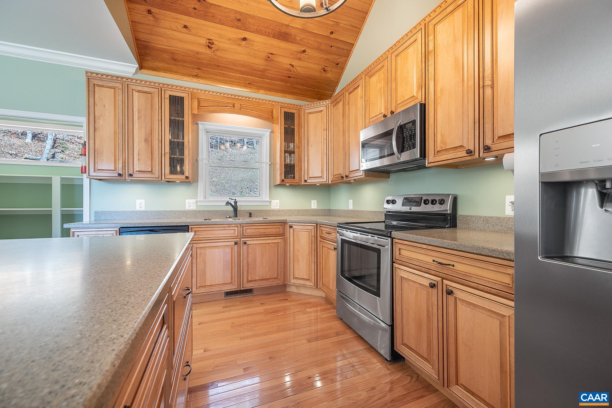 909 Gap Bridge Road Moneta, VA 24121 - Photo 32 of 75 a kitchen with stainless steel appliances granite countertop a stove a sink and a microwave