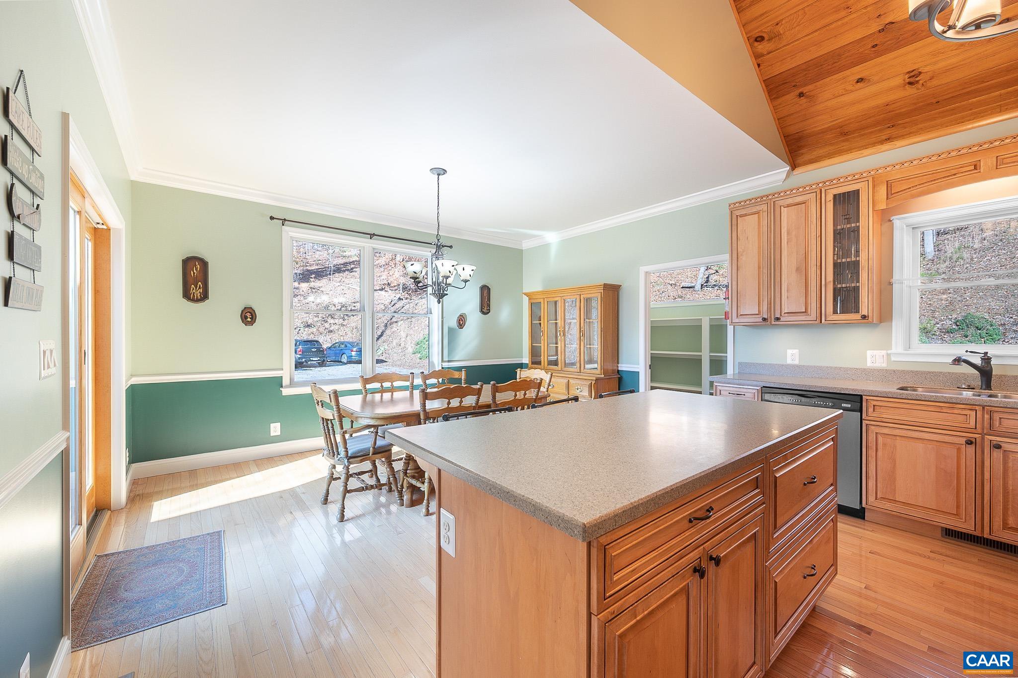 909 Gap Bridge Road Moneta, VA 24121 - Photo 33 of 75 a kitchen with a table chairs stove and wooden floor