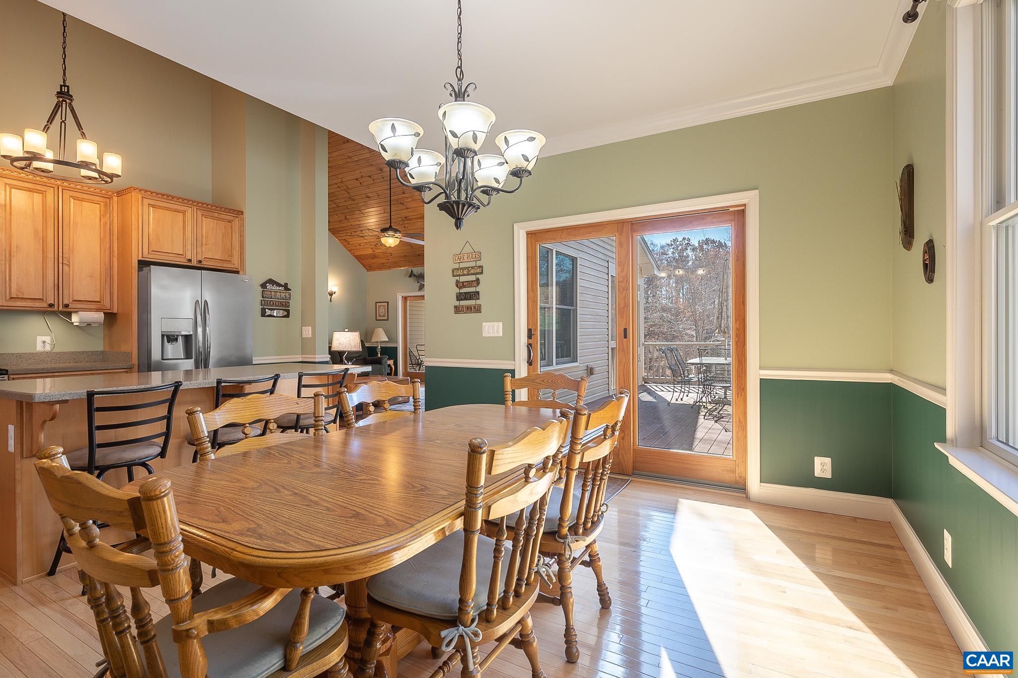909 Gap Bridge Road Moneta, VA 24121 - Photo 35 of 75 a view of a dining room with furniture a chandelier and wooden floor