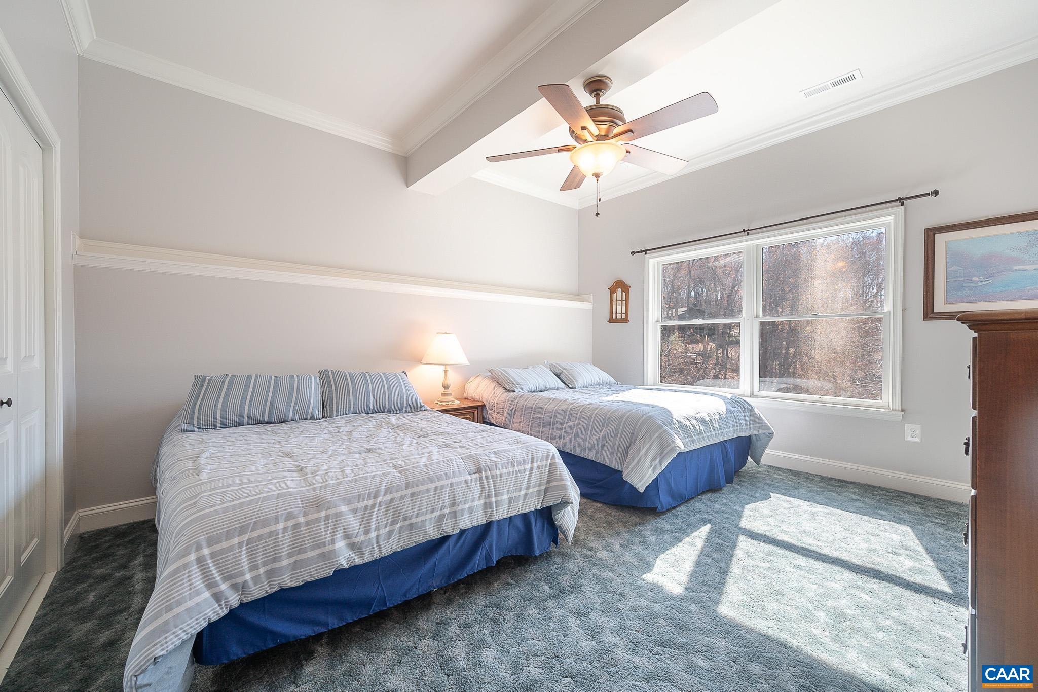 909 Gap Bridge Road Moneta, VA 24121 - Photo 61 of 75 a bedroom with two beds chandelier and a window