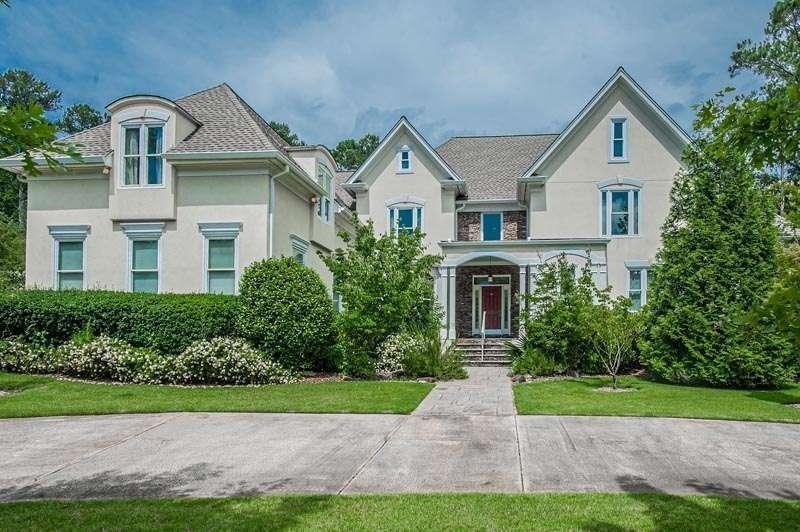 a front view of house with yard and green space