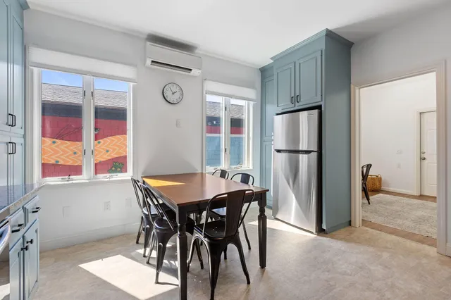 a bedroom with a bed a table and chair