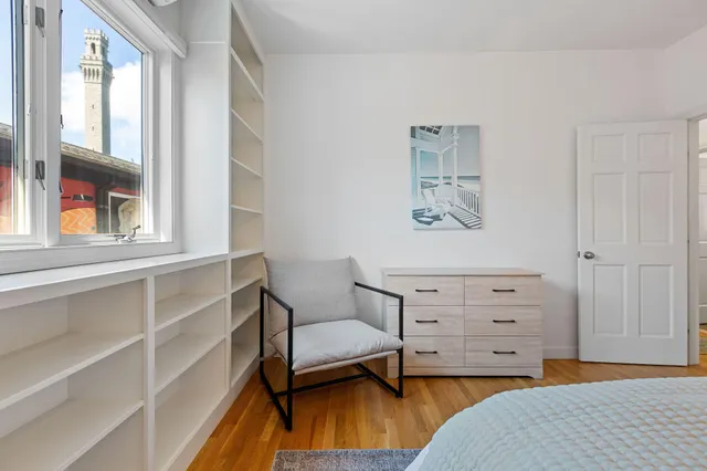 a spacious bedroom with a bed and window