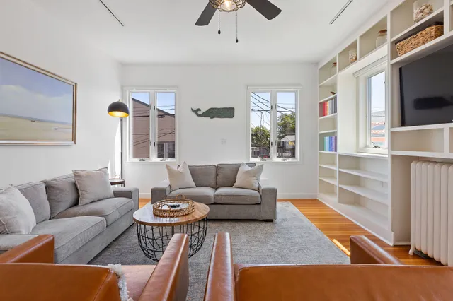 a living room with furniture rug and window