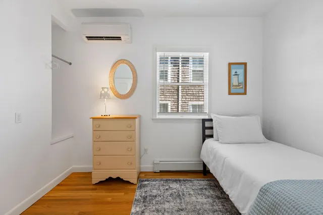 a bedroom with a bed and a chair