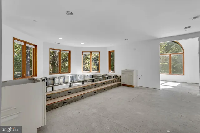 a spacious bedroom with a large bed and a large window