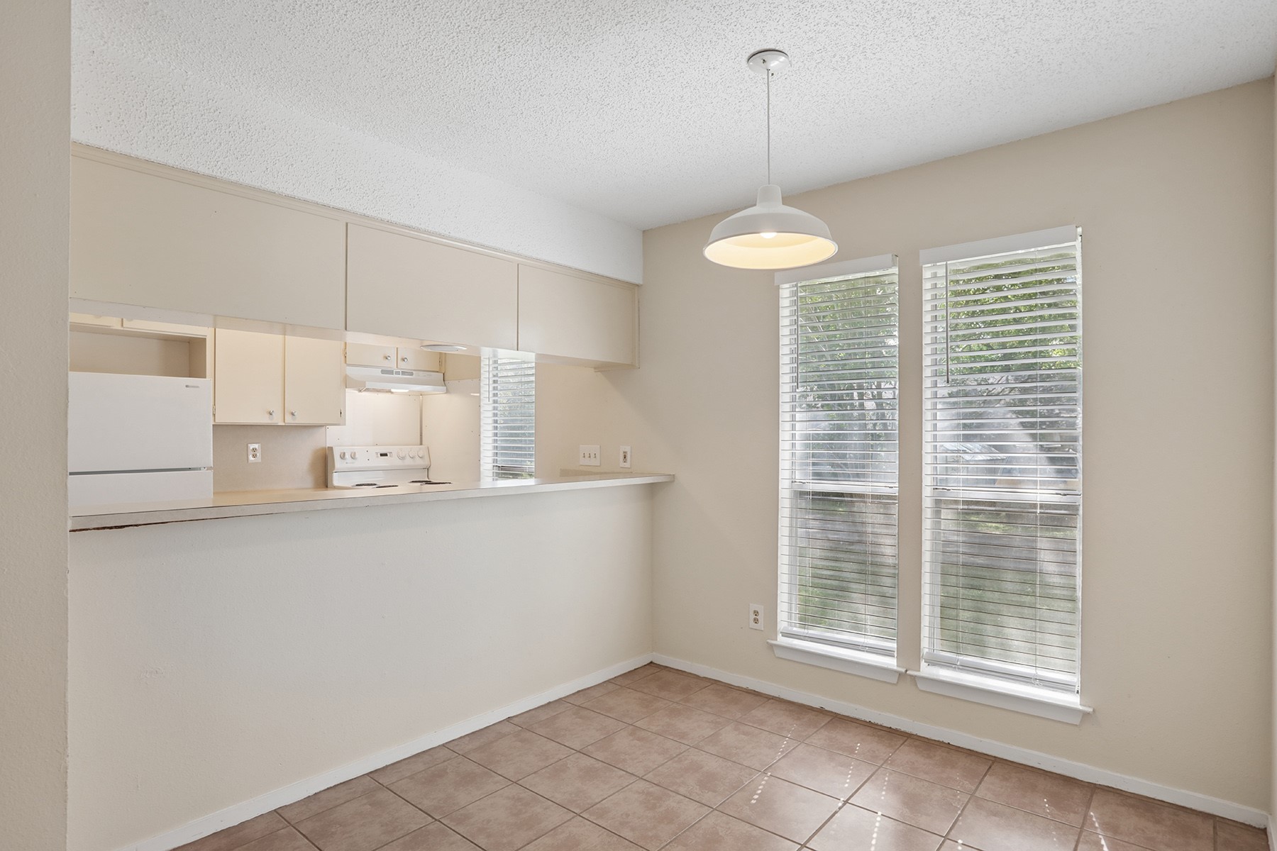 3114 Plantation Road, Unit A Austin, TX 78745 - Photo 5 of 15 A casual eat-in kitchen with a convenient breakfast bar, perfect for daily meals.