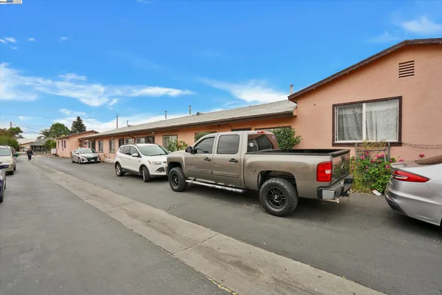 a view of cars parked in front of a house