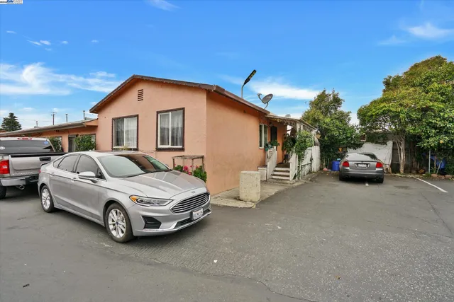 a car parked in front of house with a yard