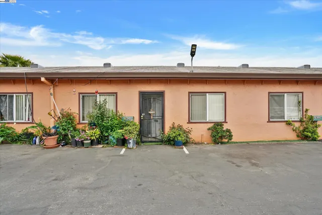 front view of a house with potted plants