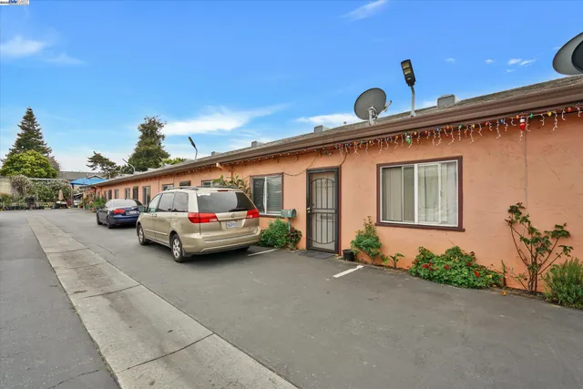 a couple of cars parked in front of a house