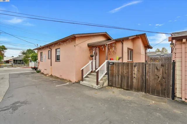 a view of a house with wooden fence