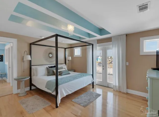 a bed sitting in a spacious bedroom next to a window