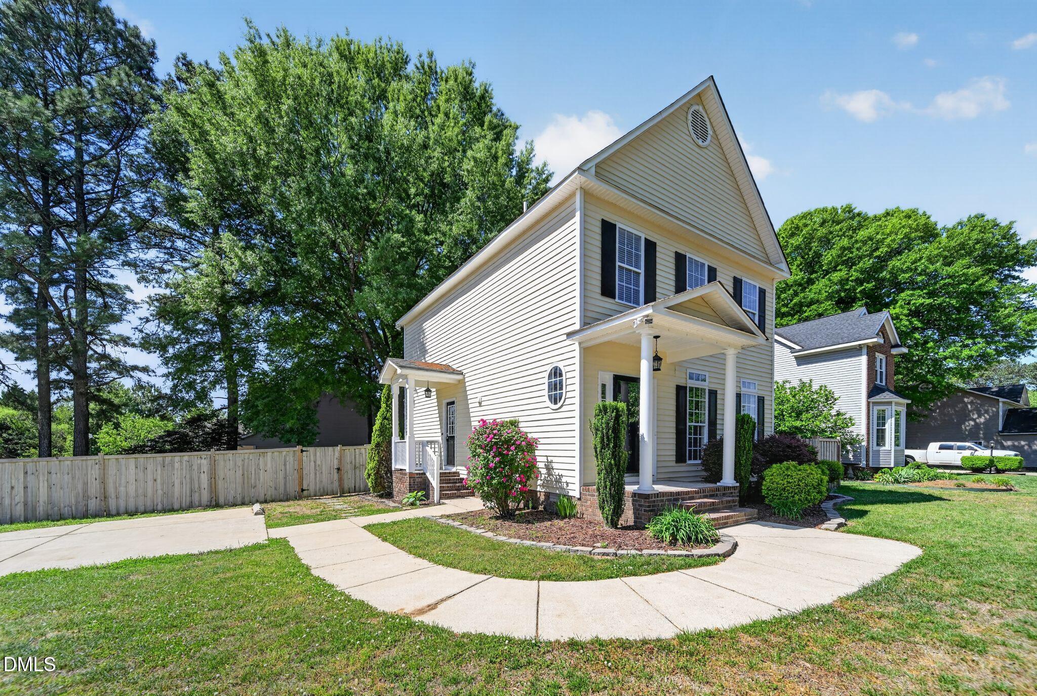 641 Commander Drive Wendell, NC 27591 - Photo 2 of 15 a view of a house with a yard potted plants and a large tree