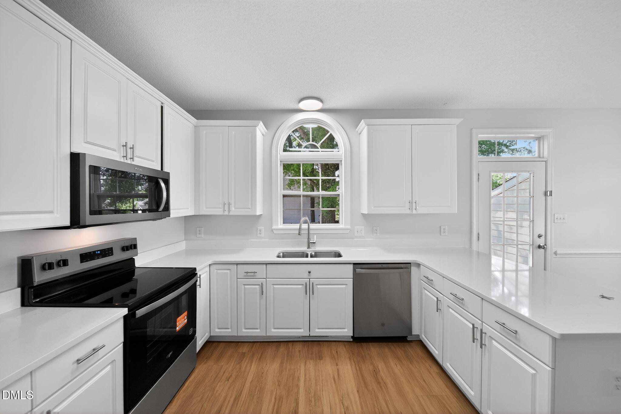 641 Commander Drive Wendell, NC 27591 - Photo 5 of 15 a kitchen with a sink a counter top space stainless steel appliances and a window