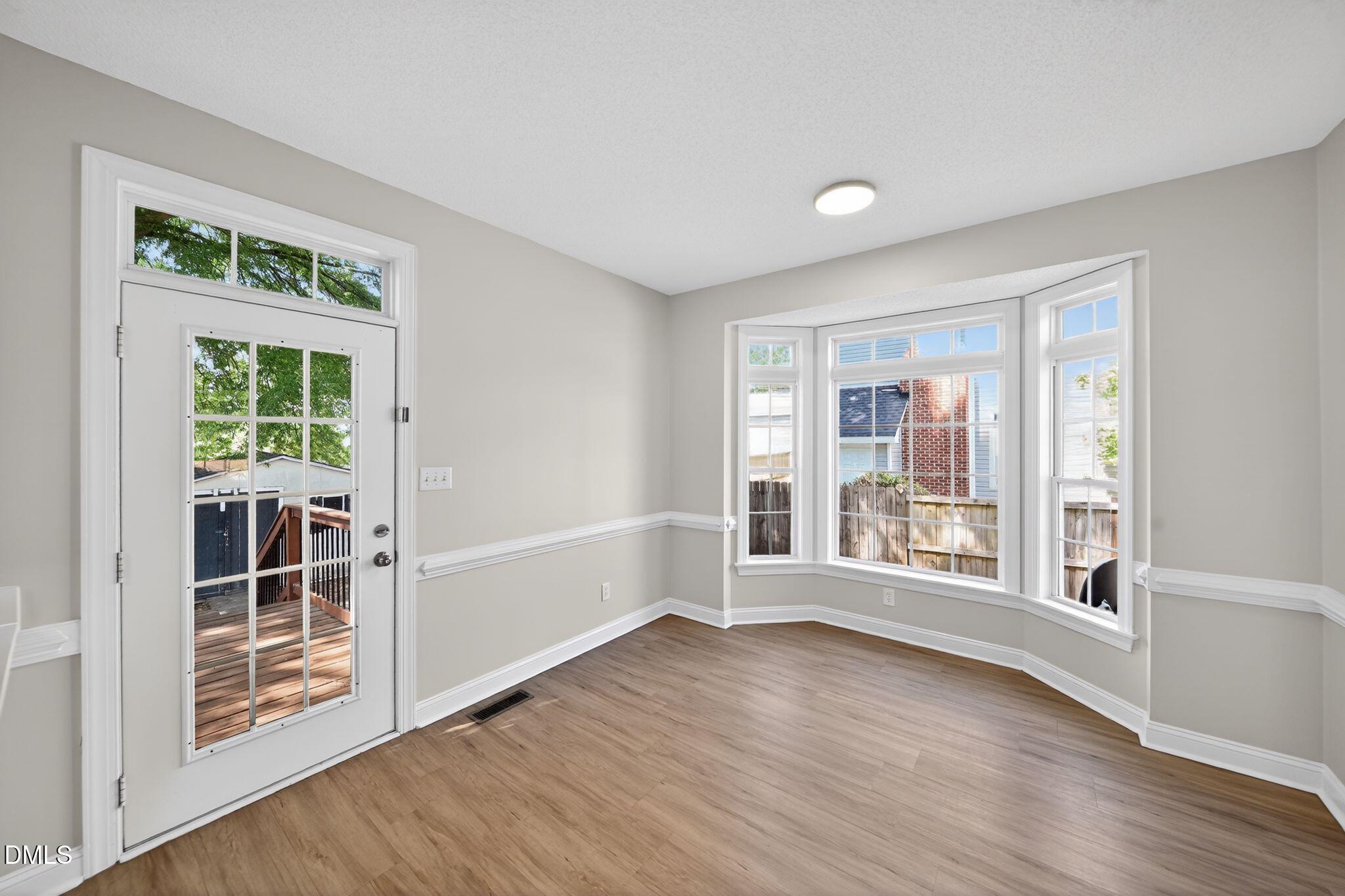 641 Commander Drive Wendell, NC 27591 - Photo 6 of 15 an empty room with wooden floor and windows