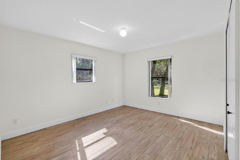171 William Street Edgewater, FL 32141 - Photo 13 of 40 an empty room with wooden floor and windows