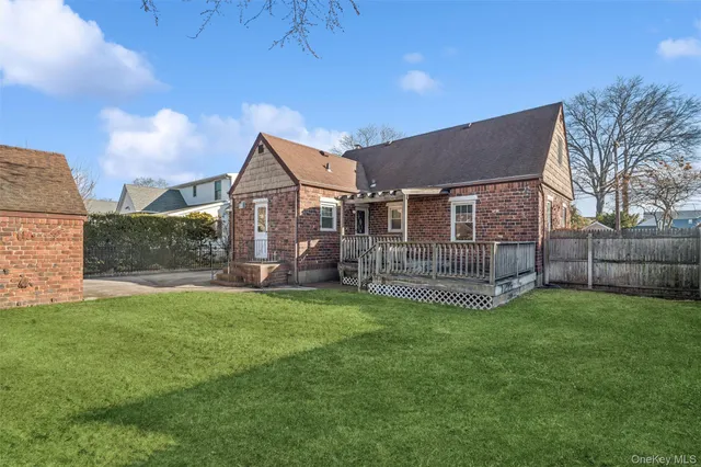 a view of a house with a yard and sitting area