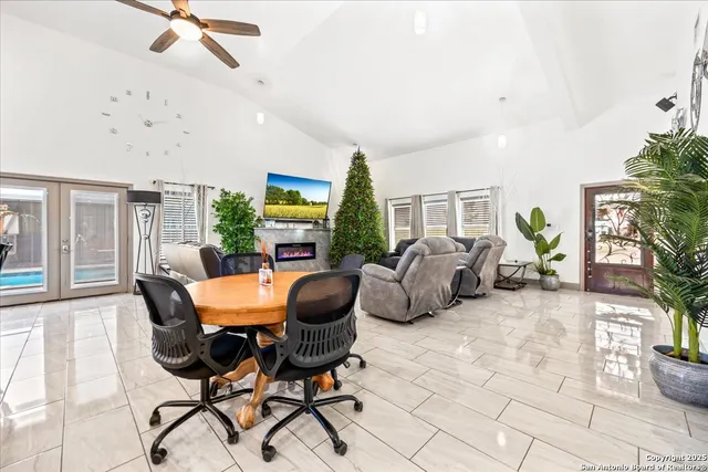 a spacious bedroom with a bed and ceiling fan