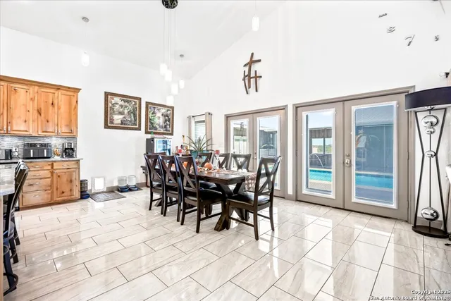 a view of a house with pool and chairs
