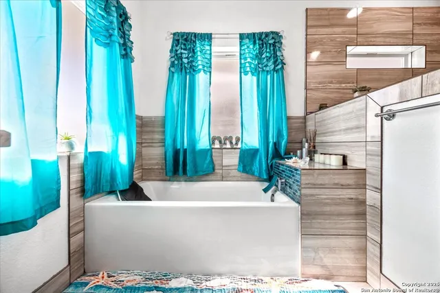 a bathroom with a granite countertop sink a toilet and a mirror