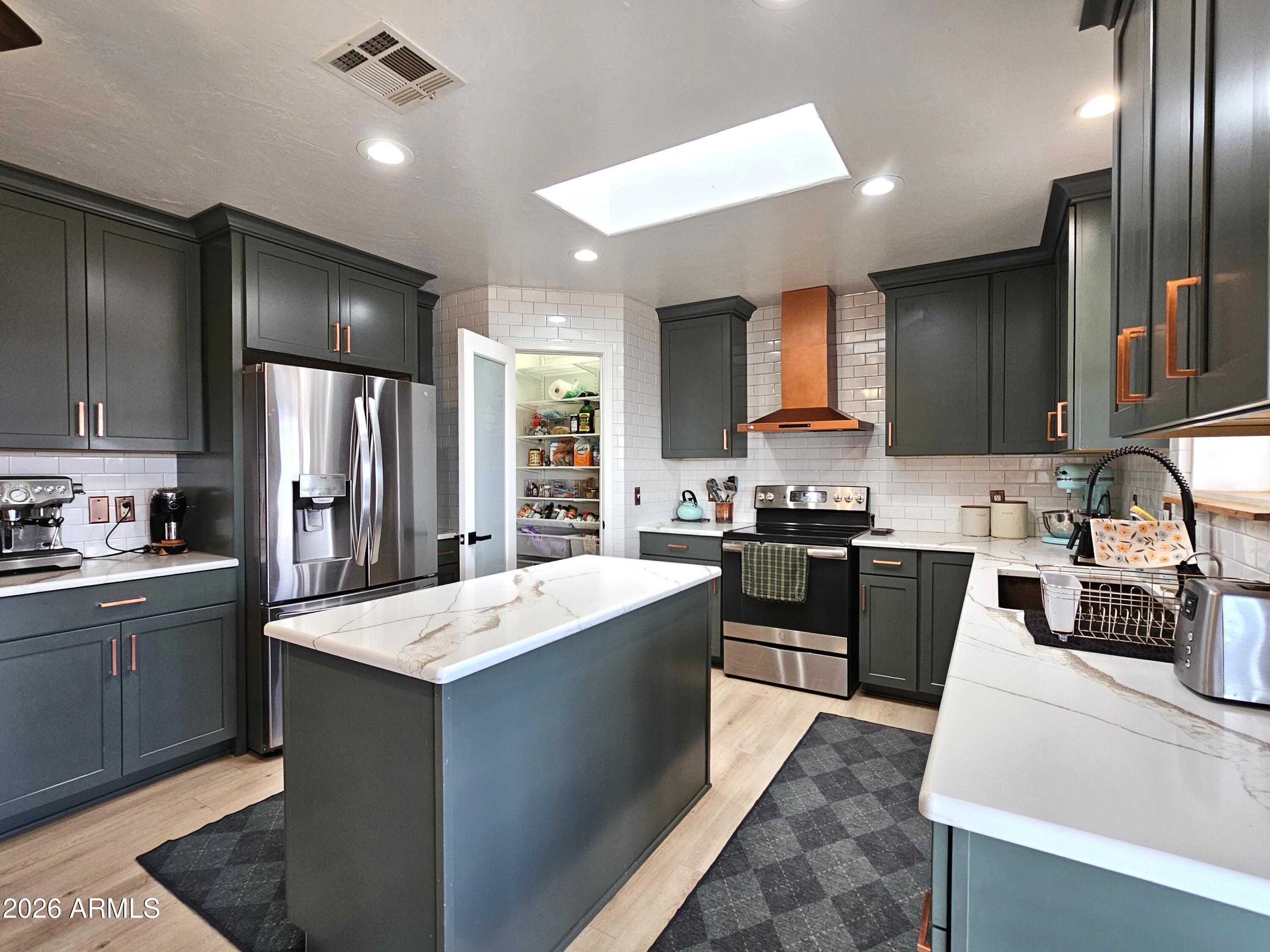 5705 South Wild Rose Road Hereford, AZ 85615 - Photo 12 of 39 a kitchen with a sink stove and refrigerator