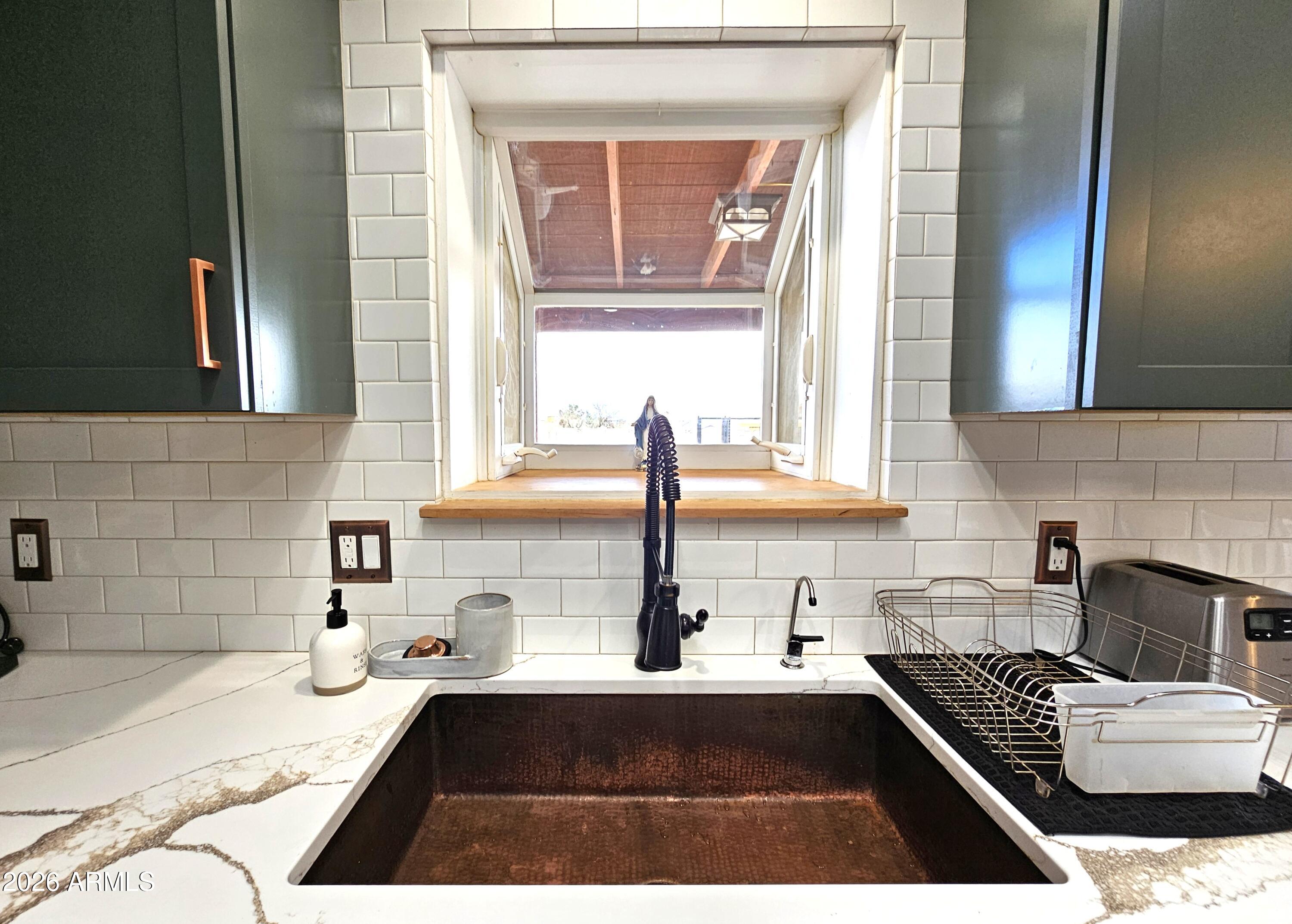 5705 South Wild Rose Road Hereford, AZ 85615 - Photo 14 of 39 a kitchen with a refrigerator a sink and white cabinets
