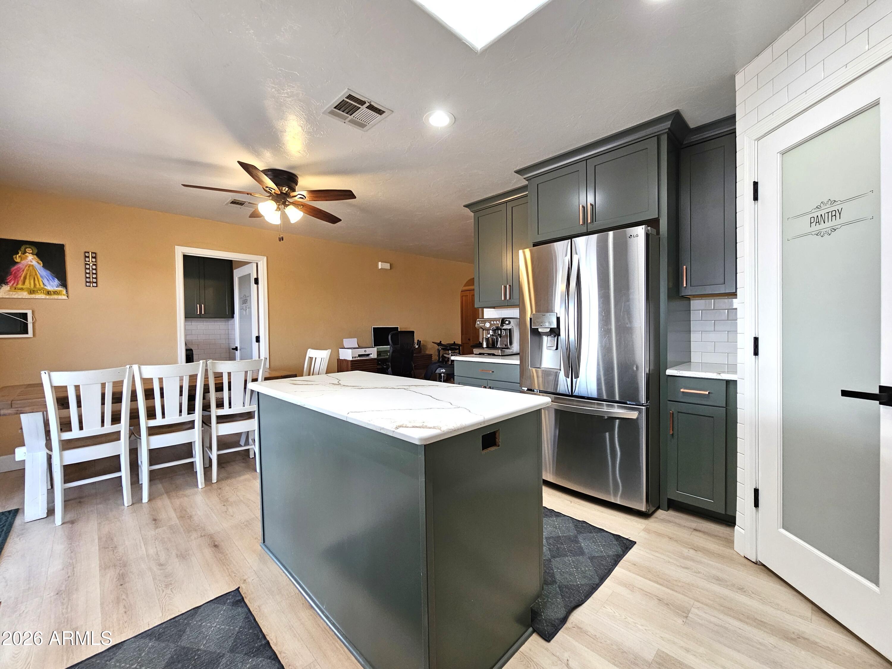 5705 South Wild Rose Road Hereford, AZ 85615 - Photo 15 of 39 a kitchen with cabinets and stainless steel appliances
