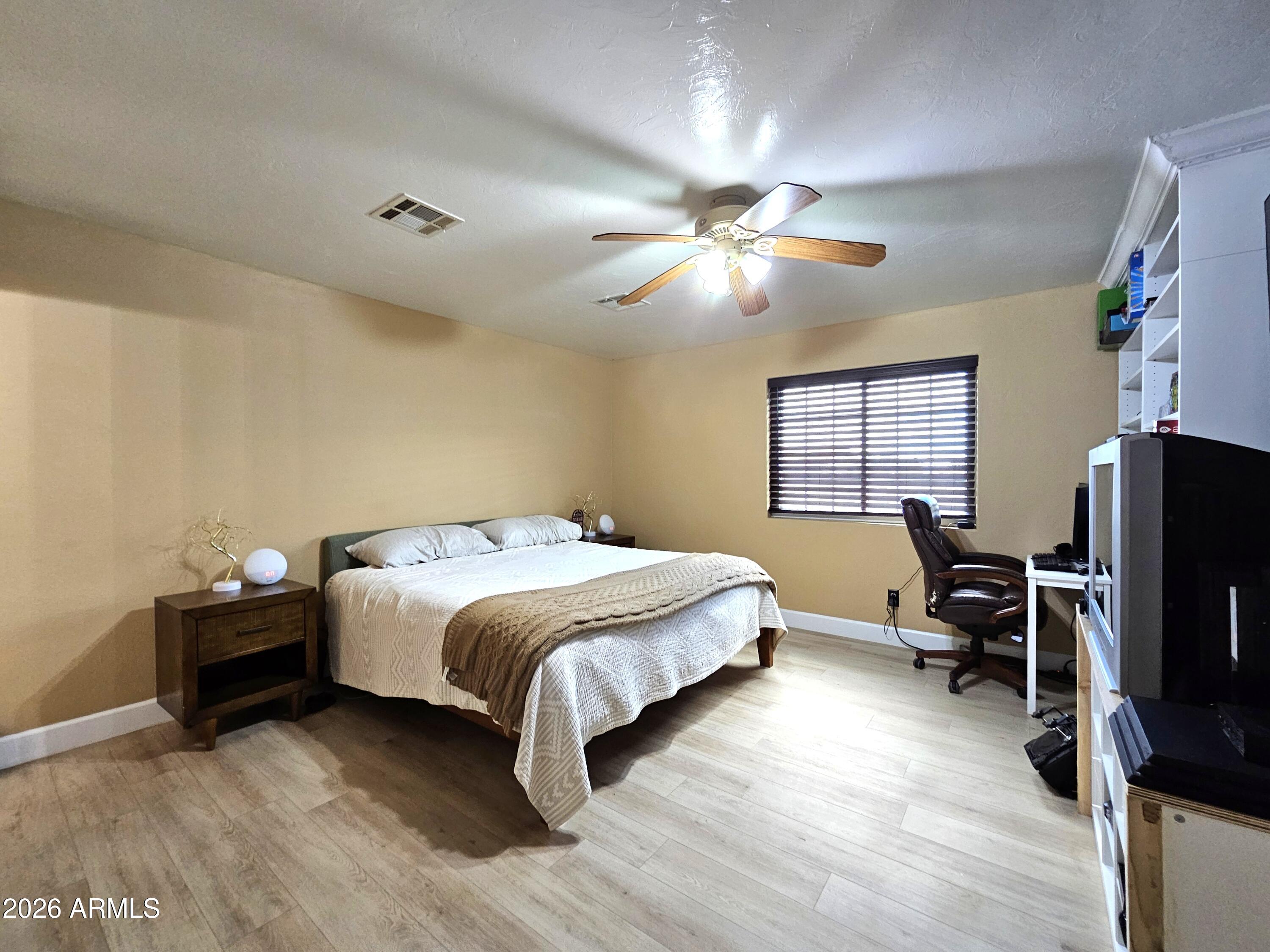 5705 South Wild Rose Road Hereford, AZ 85615 - Photo 18 of 39 a bedroom with a bed furniture and a flat screen tv