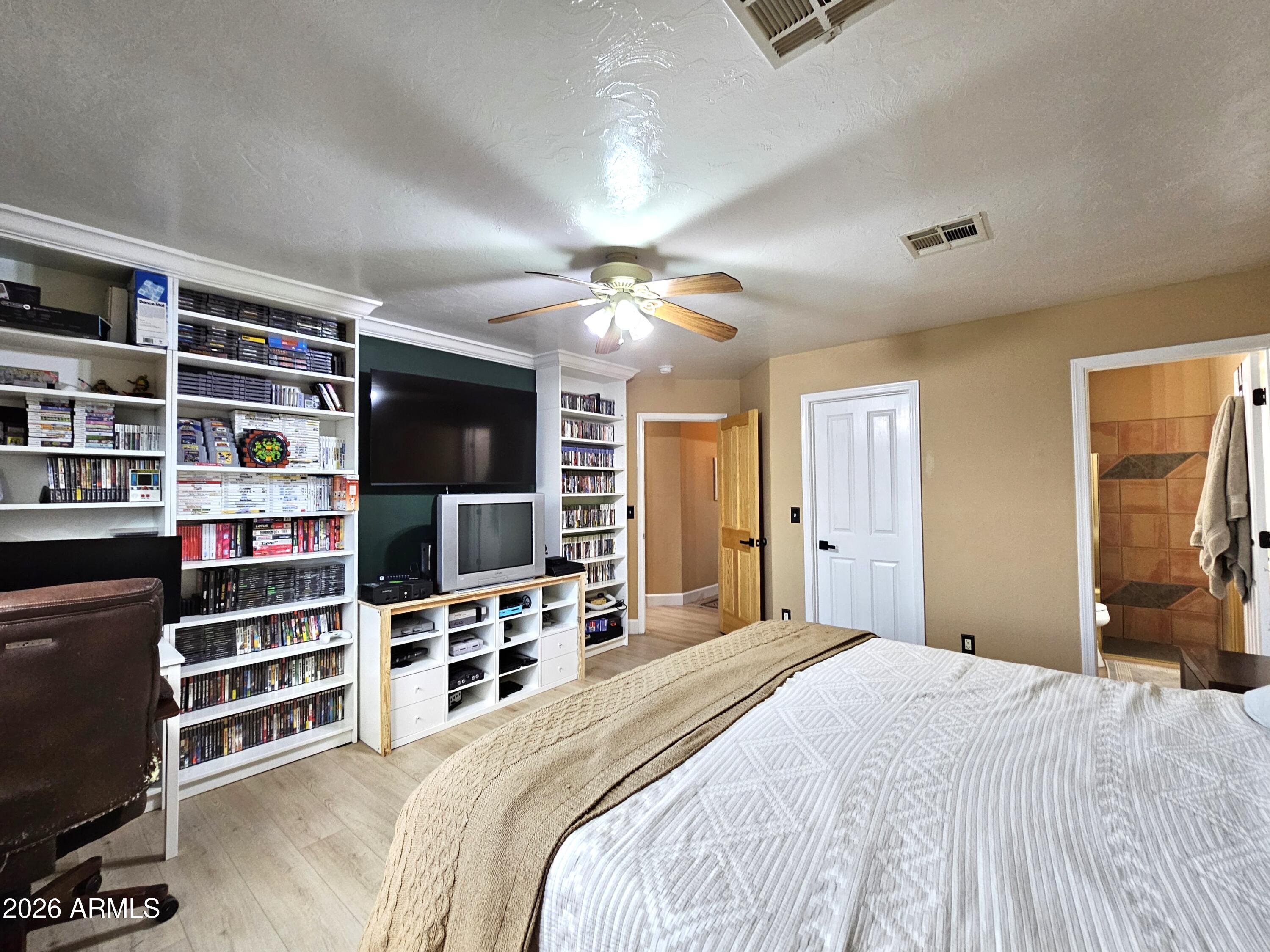 5705 South Wild Rose Road Hereford, AZ 85615 - Photo 19 of 39 a bedroom with a bed and a flat screen tv