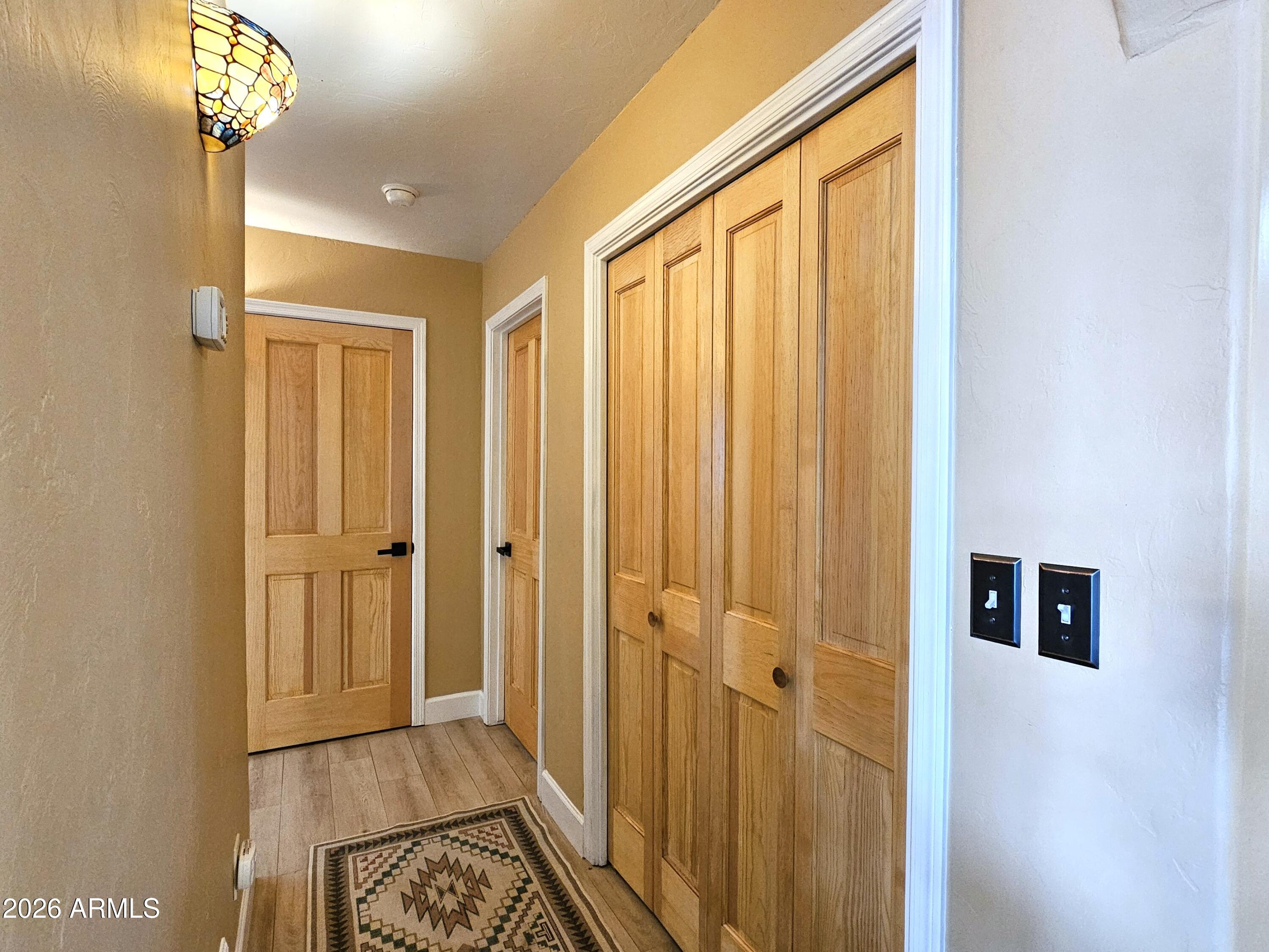 5705 South Wild Rose Road Hereford, AZ 85615 - Photo 22 of 39 a view of a hallway with wooden floor and staircase