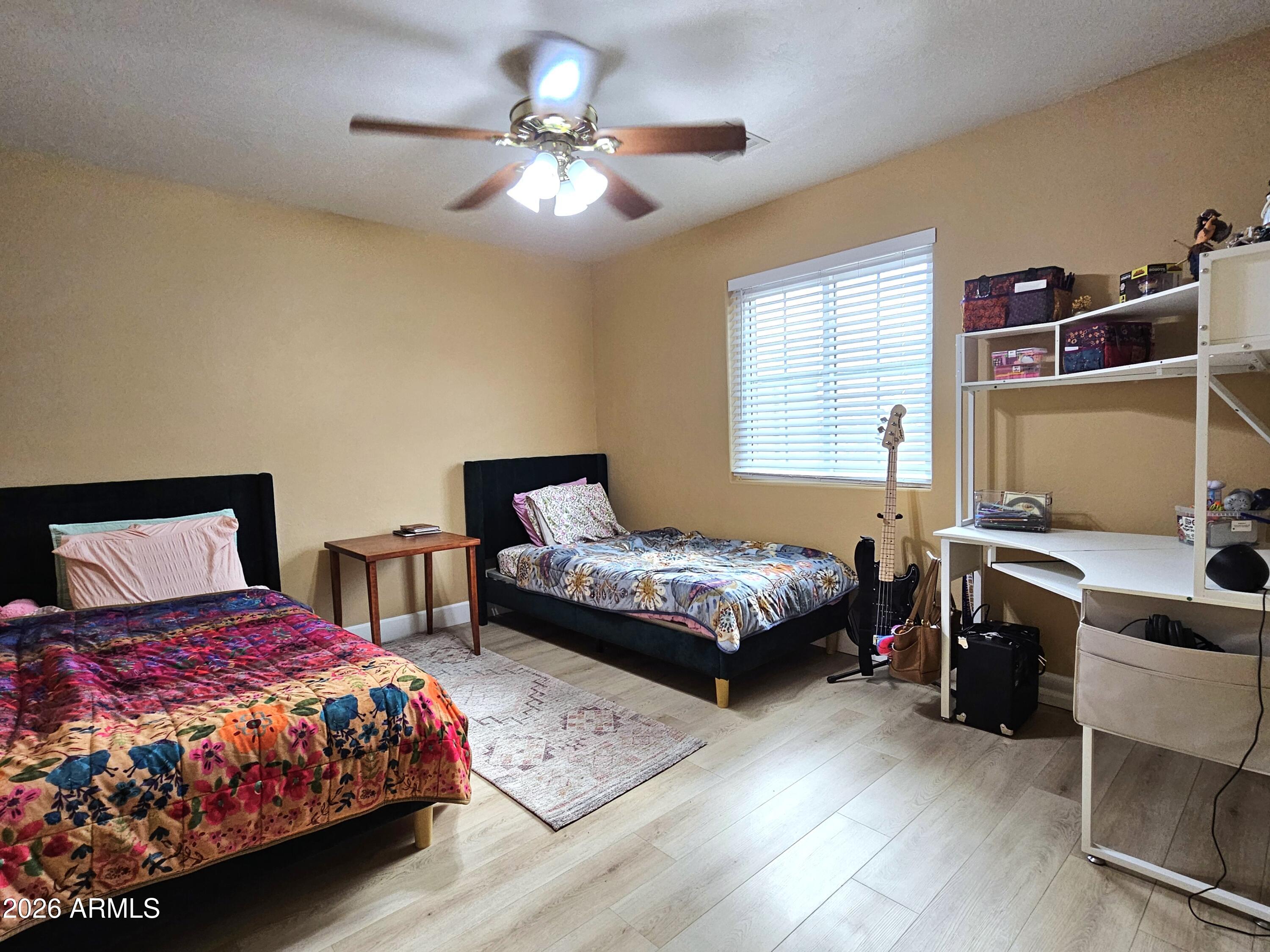 5705 South Wild Rose Road Hereford, AZ 85615 - Photo 24 of 39 a bedroom with a bed and a chandelier