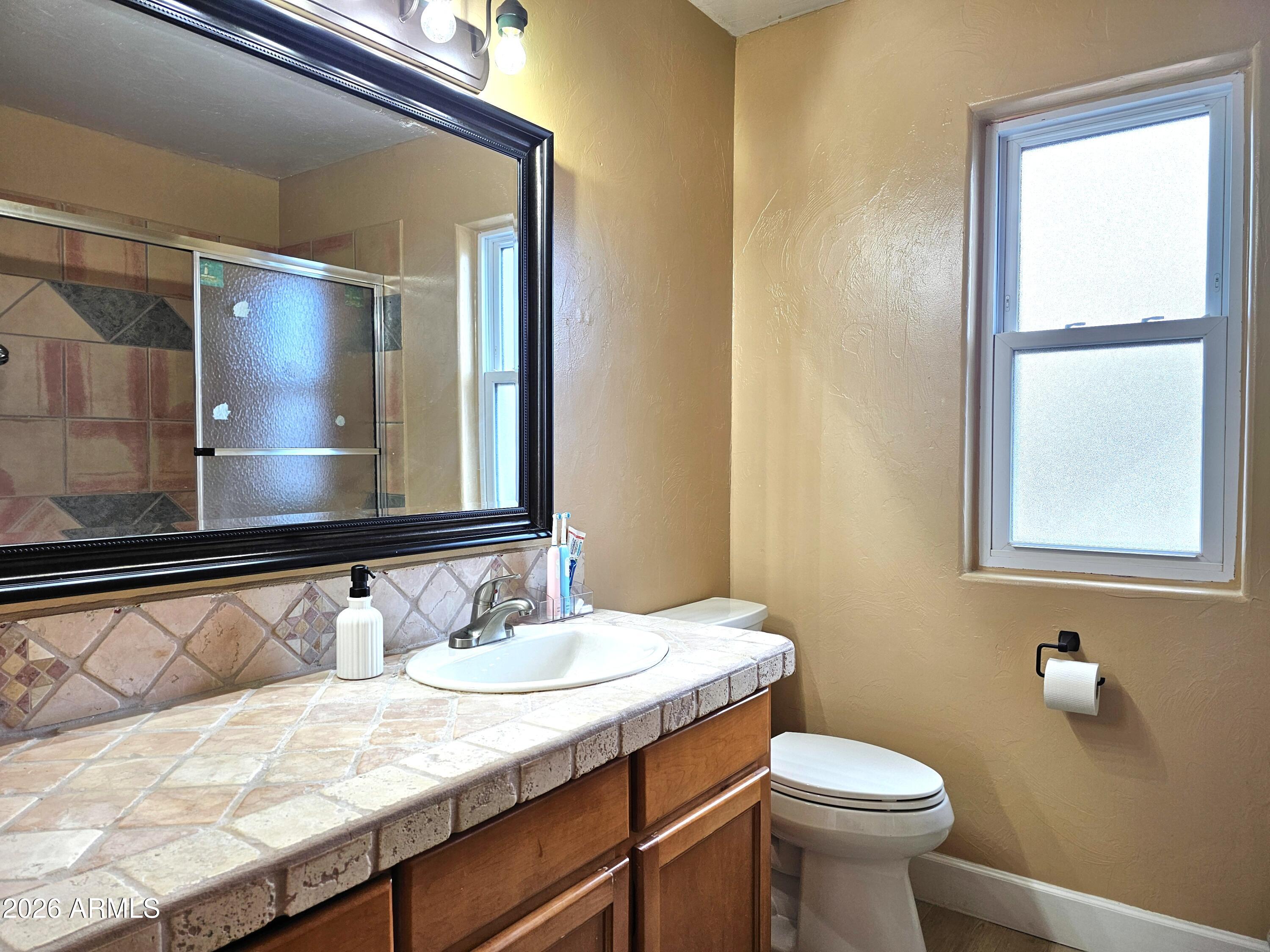 5705 South Wild Rose Road Hereford, AZ 85615 - Photo 25 of 39 a bathroom with a sink and a mirror